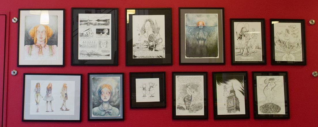 Red wall featuring the works of illustrator François Amoretti, from Scotland to New York via Russia