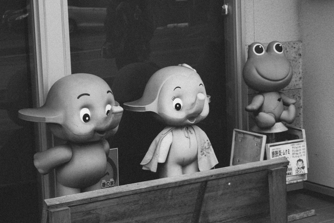 Vintage 1950s or 1960s elephant figurins on display in front of a japanese store