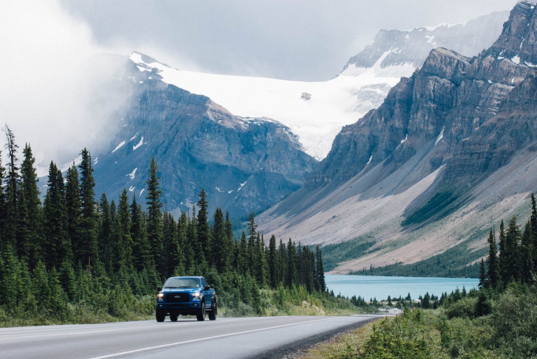 Highway arriving at Bow Lake with mountains in the background