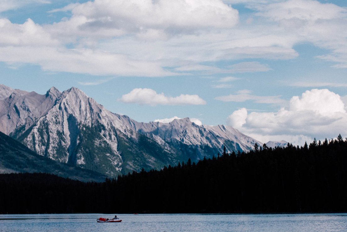 Boat on Johnston Lake with mountains in the background