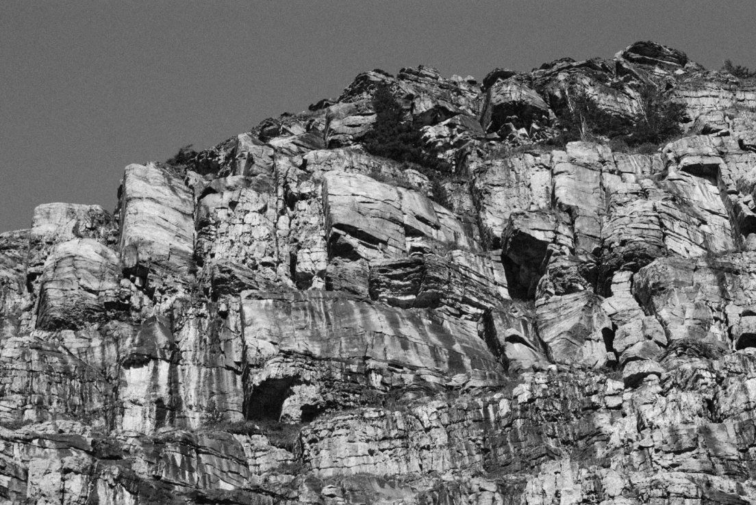 Black and white photograph of a cliff on the Three Glaciers Trail