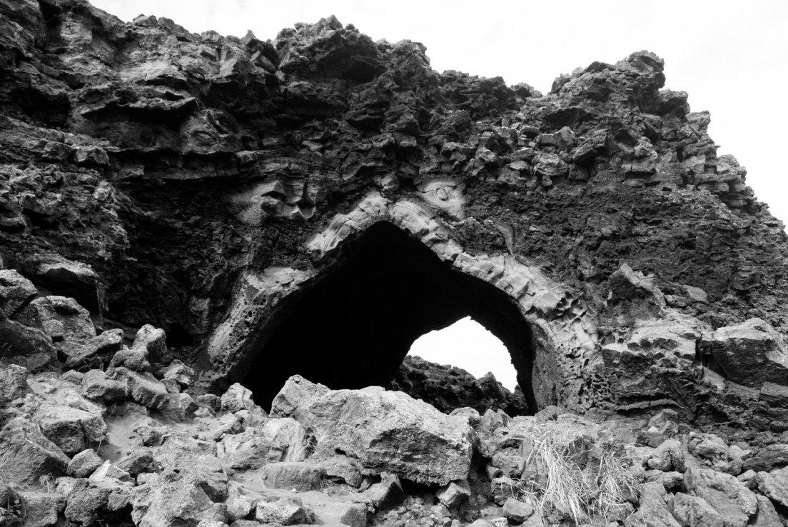 Black and white photograph of an archaway into the dimmuborgir