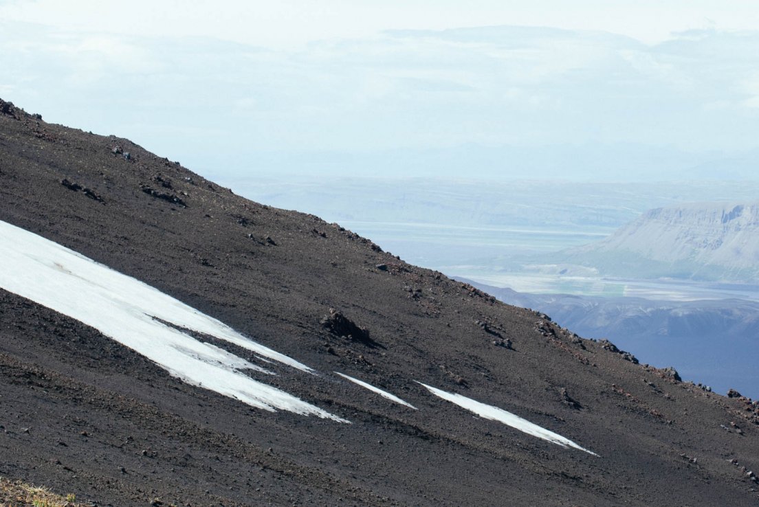 Snow and ashes on the slope of the volcano