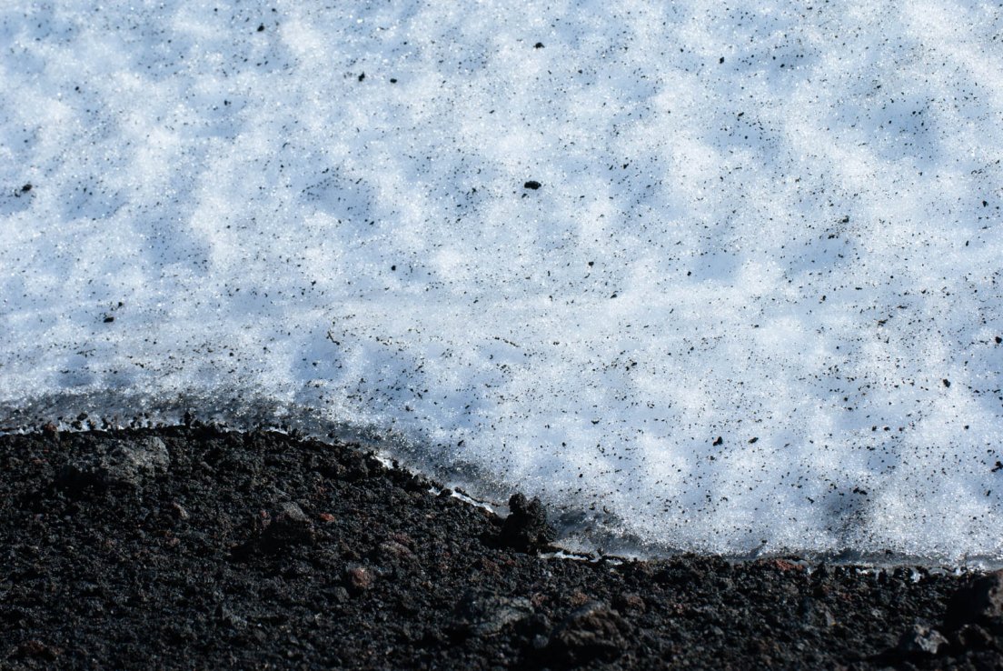 Snow and ashes on the slope of the volcano