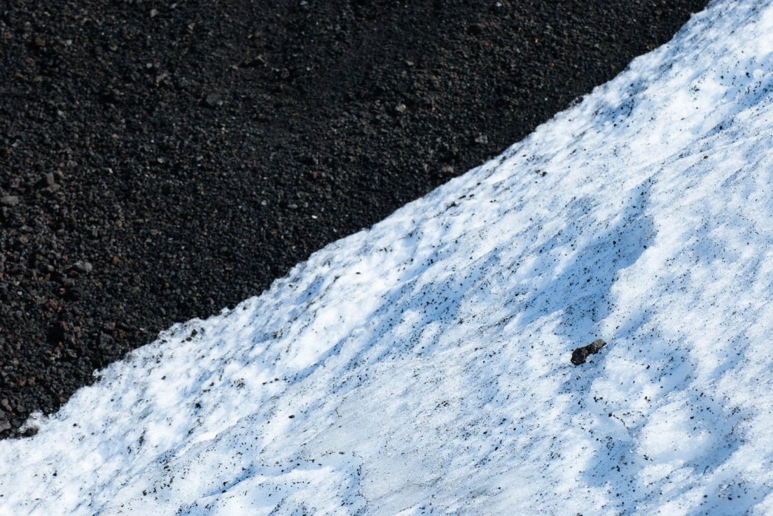 Snow and ashes on the slope of the volcano