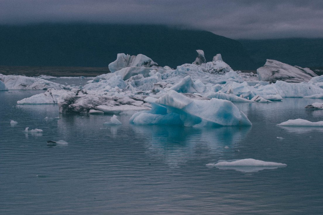 Moody photograph of a lake populated by icebergs