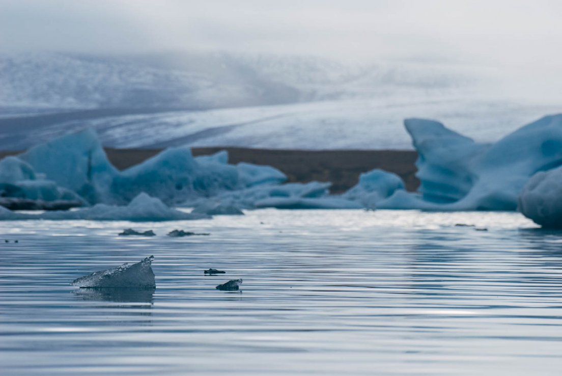 Tiny chunk of ice before much larger icebergs and a massive ice field