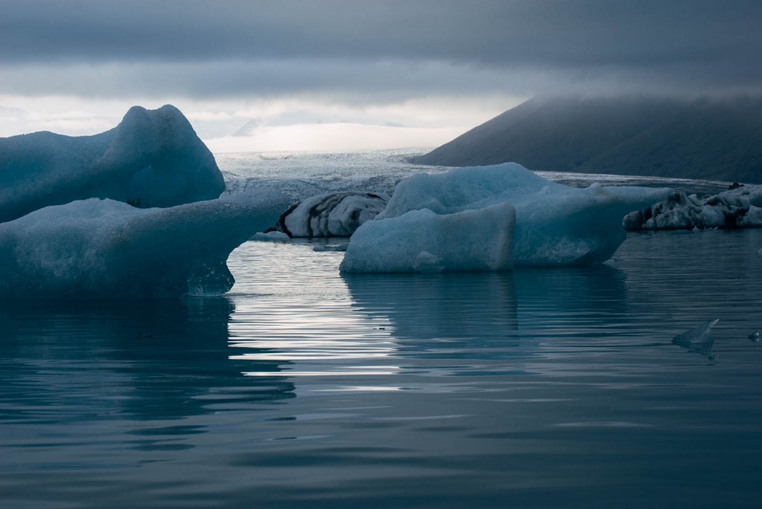 Clouds, sun, ice and a lake