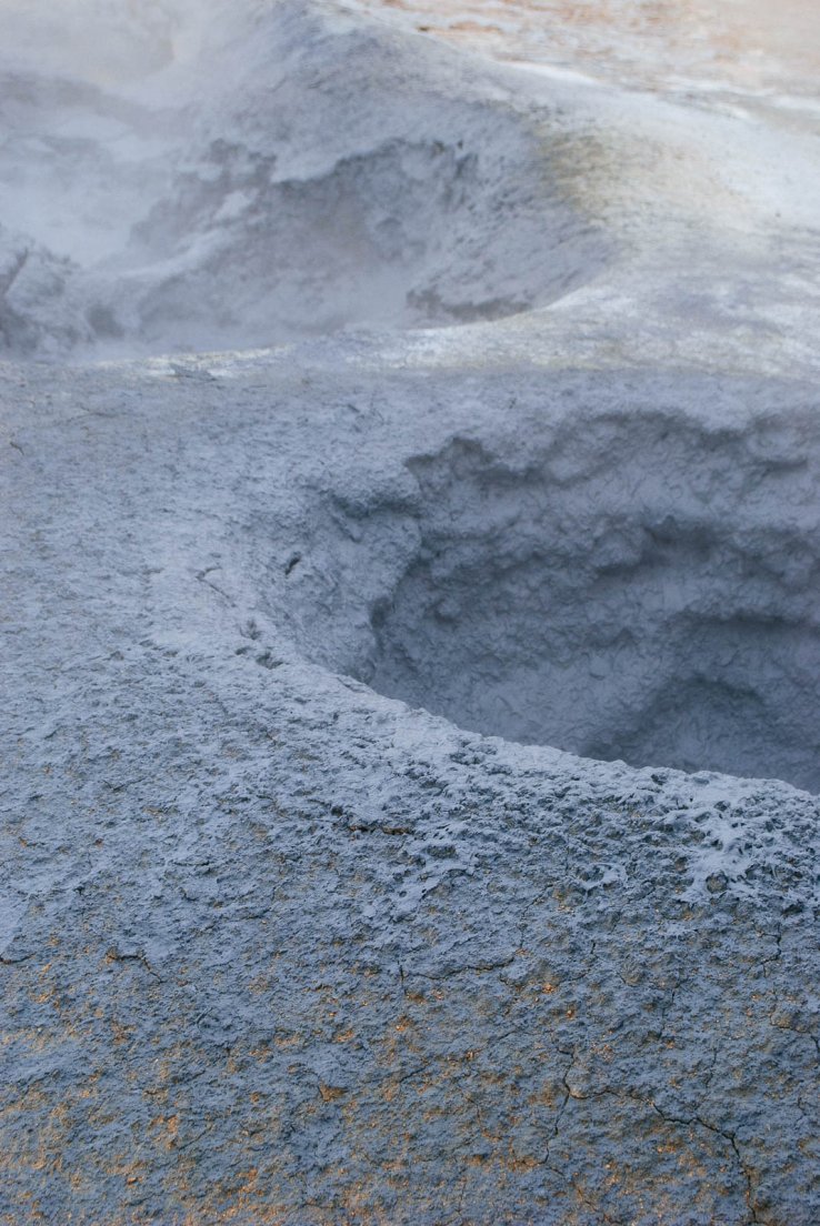 Holes of bubbling black mud with a slight touch of orange dust mixed in, Námafjall #009, Iceland, 3rd august 2017 Holes of bubbling black mud with a slight touch of orange dust mixed in