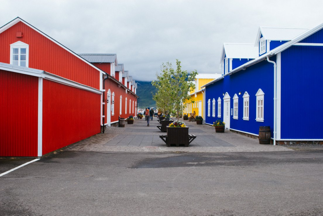 Corrugated metal houses in bold colours, red, blue, yellow
