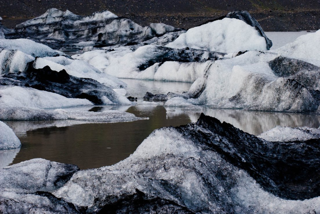 Half-melted and blackened icebergs