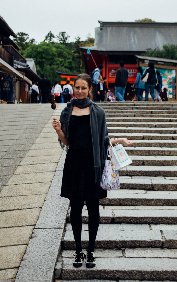 A western girl obligingly posing at the entrance of the Fushimi Inari temple holding a dango, Ascension du Fushimi Inari #001, 11 may 2016 A western girl obligingly posing at the entrance of the Fushimi Inari temple holding a dango