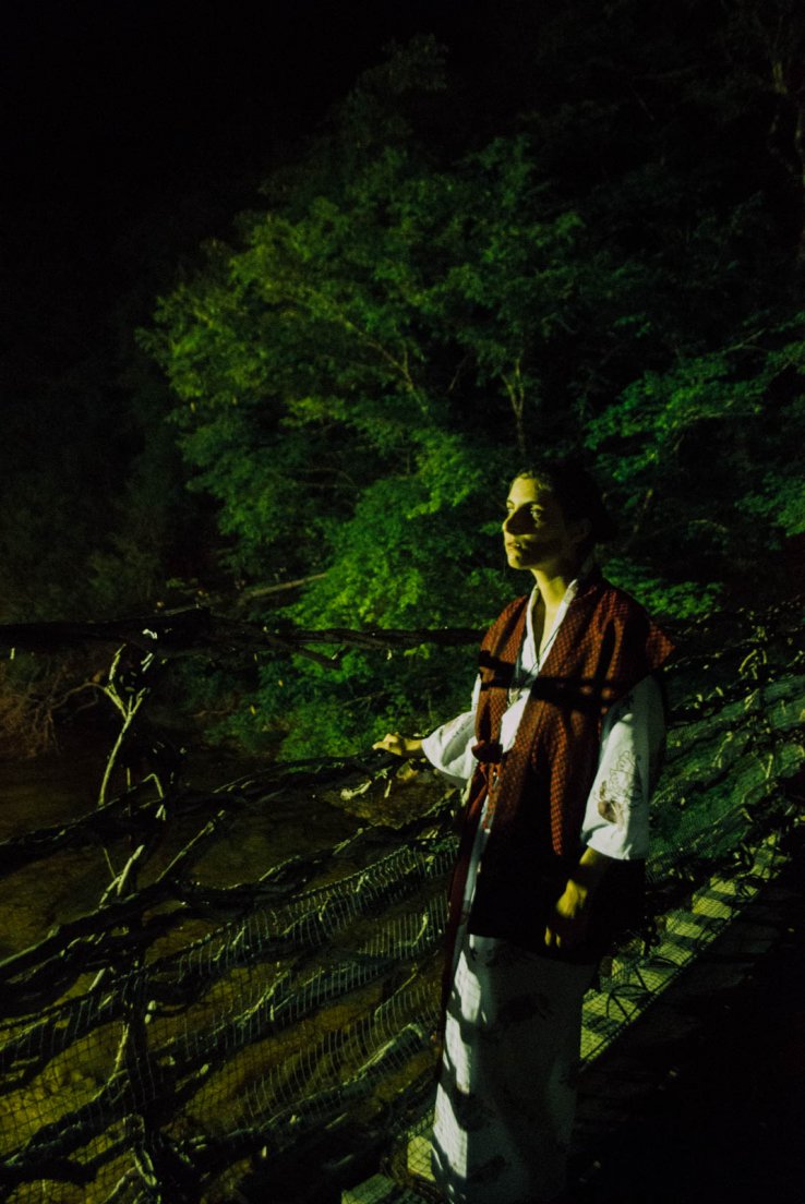 A western girl in a yukata on a suspended bridge by night