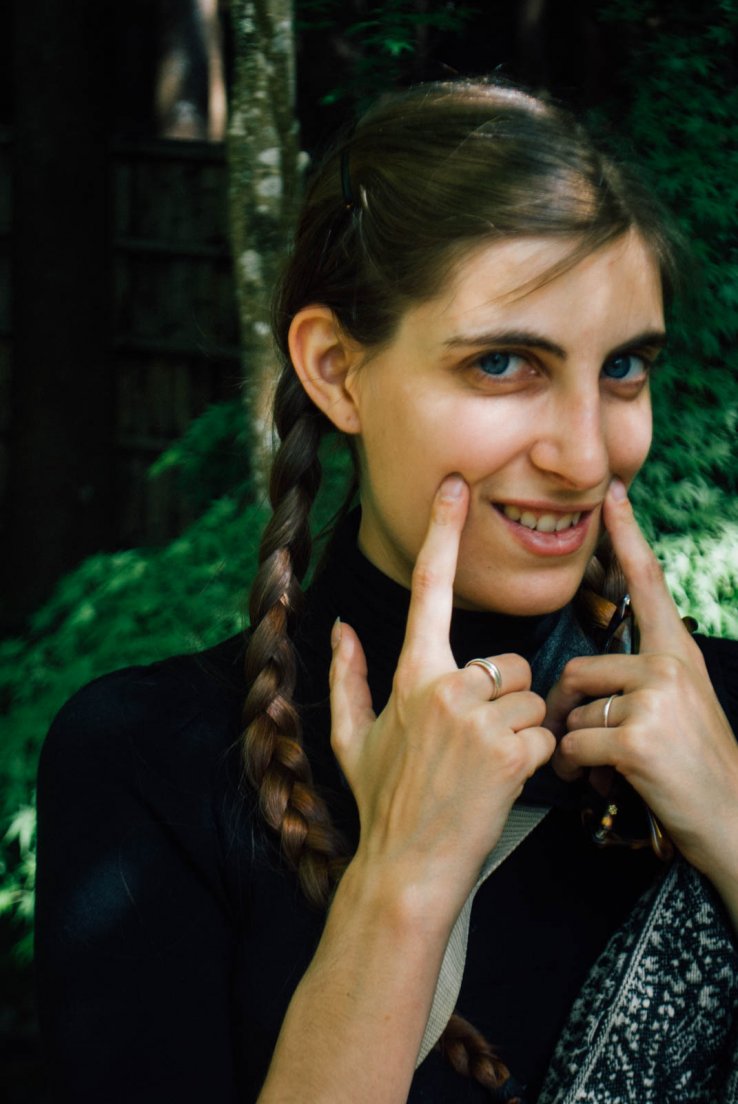 Portrait of a western girl with braids doing an imitation of japanese kawaii posing, First day in Kyoto #036, Ginkaku-ji, Kyoto, Japan, 08 may 2016 Portrait of a western girl with braids doing an imitation of japanese kawaii posing
