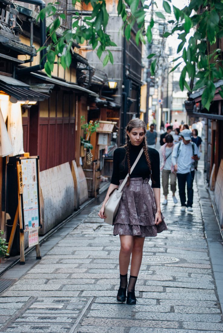Streetsnap of a western girl with braids, a cream leather satchel, a black top and an Innocent World chess pattern skirt, First day in Kyoto #061, Gion Tatsumi bridge, Kyoto, Japan, 08 may 2016 Streetsnap of a western girl with braids, a cream leather satchel, a black top and an Innocent World chess pattern skirt