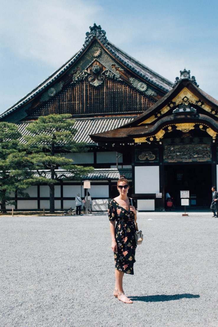 Young girl posing in a Seamstress of Bloosmbury dress in the courtyard of a japanese castle