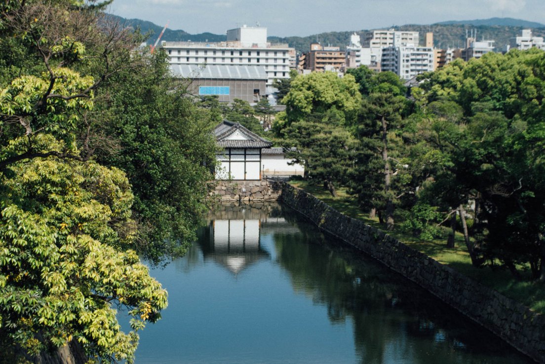 Moats of the castle in front of Kyoto modern buildings