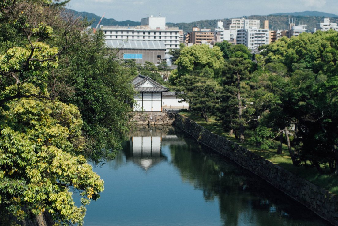 Moats of the castle in front of Kyoto modern buildings, Nijō-jo castle #021, 13 may 2016 Moats of the castle in front of Kyoto modern buildings