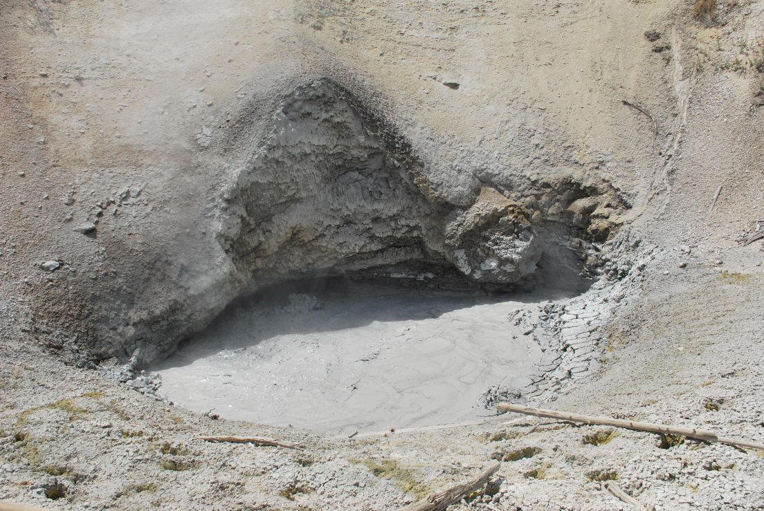A mud pot shaped like a dinosaur foot track