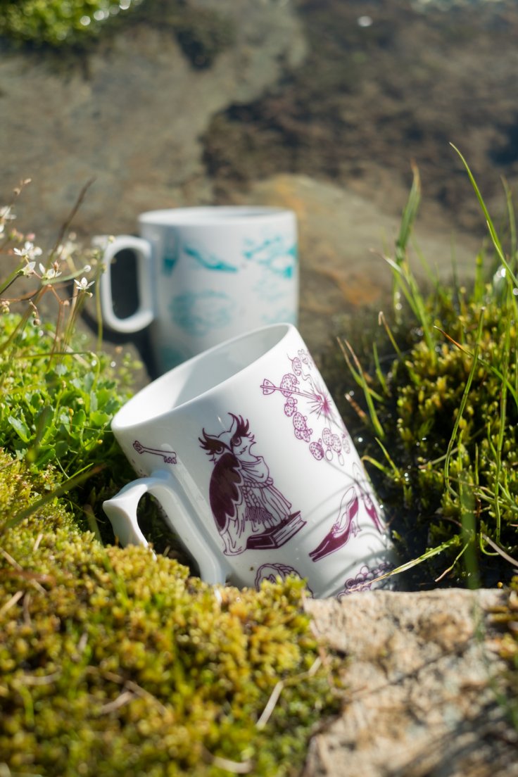 Purple and seafoam mugs from Enchanteresse, a hand-painted porcelain collection by messalyn, in a stream from the mountain